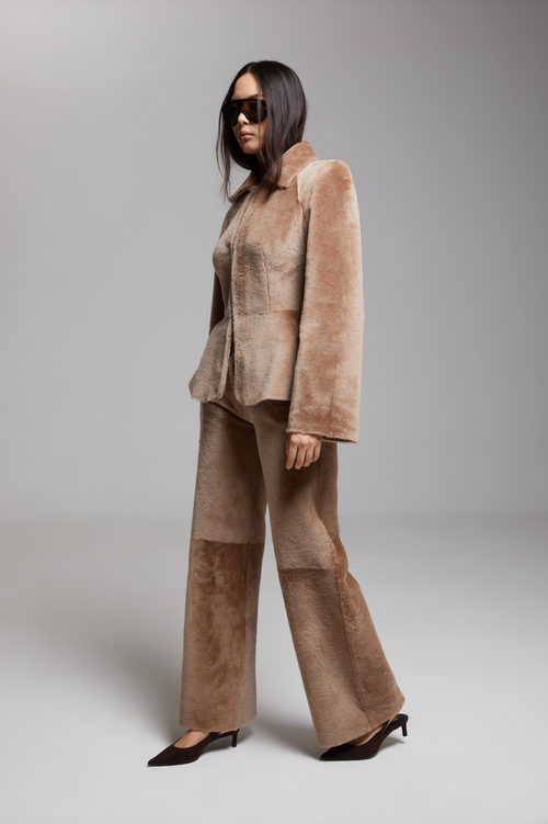 BIENBIE Allegro shearling pants in beige, featuring a cozy, plush shearling exterior and relaxed fit for casual wear.