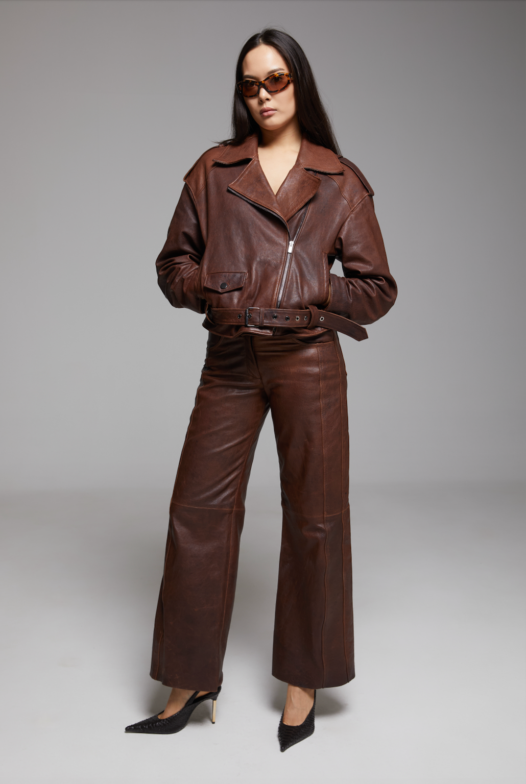 Black BIENBIE Rondo Jacket with a sleek design and front zipper, shown on a hanger.
