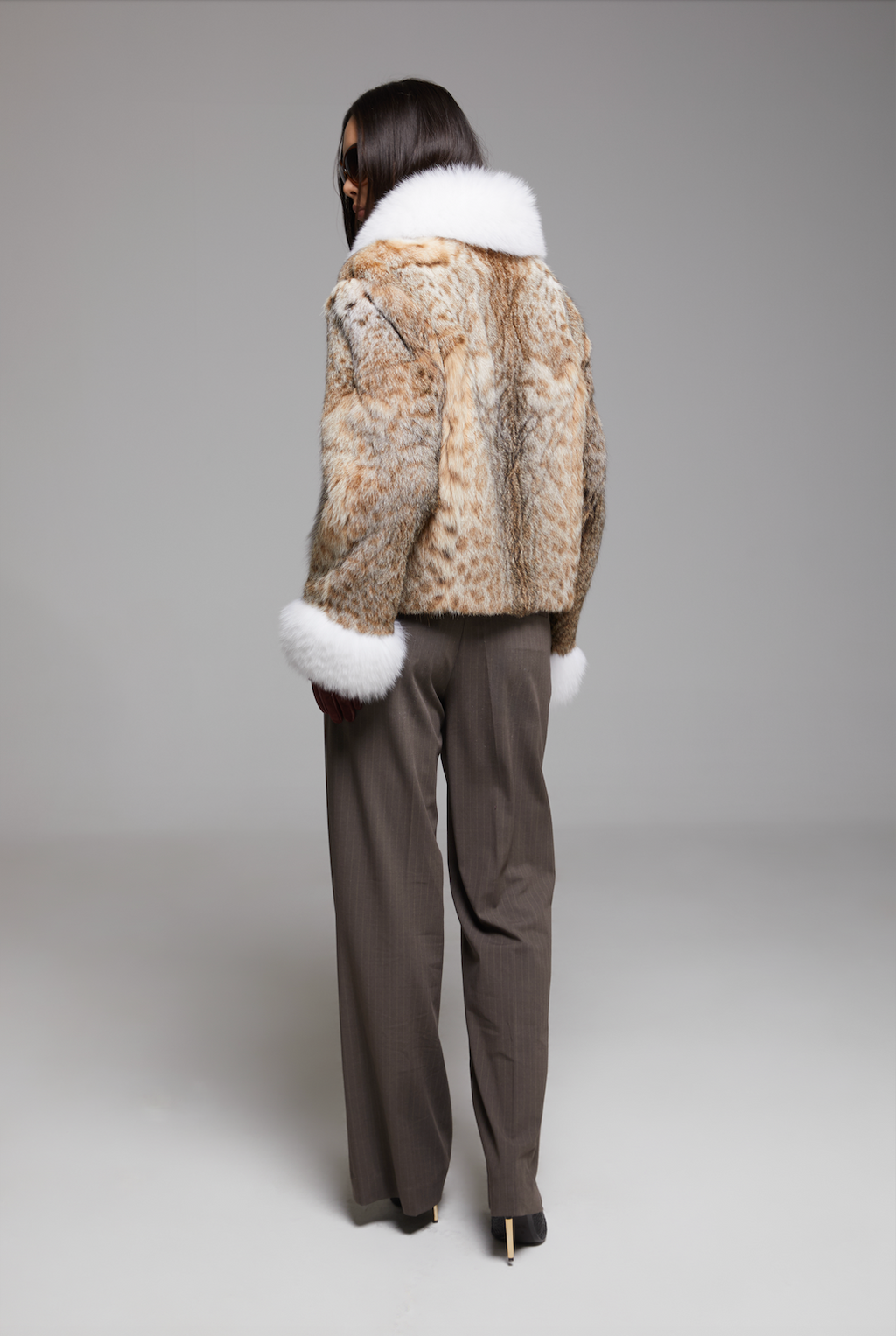 BIENBIE Intermezzo Coat displayed on a hanger, showing its stylish design and fabric details in a well-lit setting.
