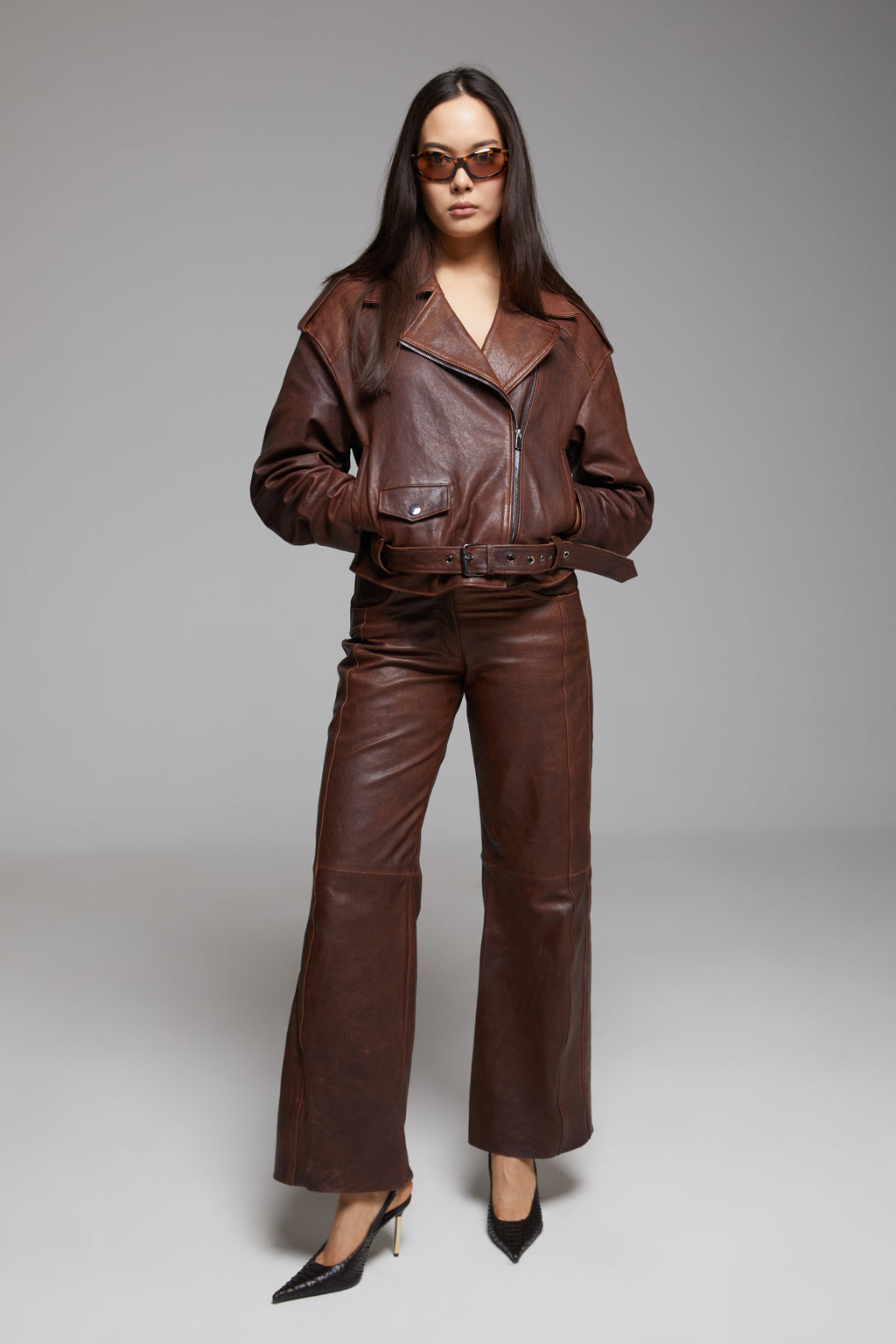 Black Rondo leather pants by BIENBIE, featuring a slim fit design and detailed stitching, shown on a model.