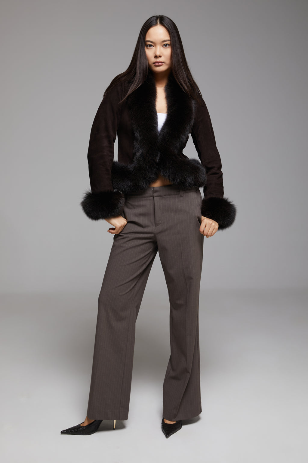 Black BIENBIE Tempo Jacket with a sleek design and zippered front, shown on a hanger against a plain background.