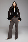 Black BIENBIE Tempo Jacket with a sleek design and zippered front, shown on a hanger against a plain background.